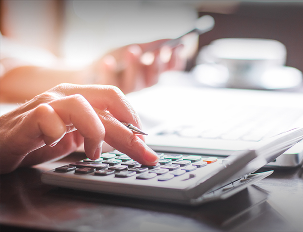 hand typing on a calculator