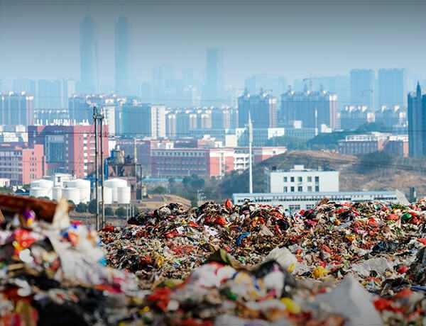 Landfill trash with city skyline in background