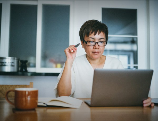 Women works on laptop computer at a table